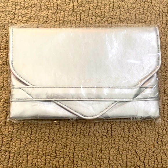 Silver clutch purse with pink interior. New.